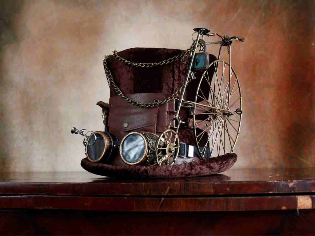 steampunk top hat with goggles and a penny farthing attached