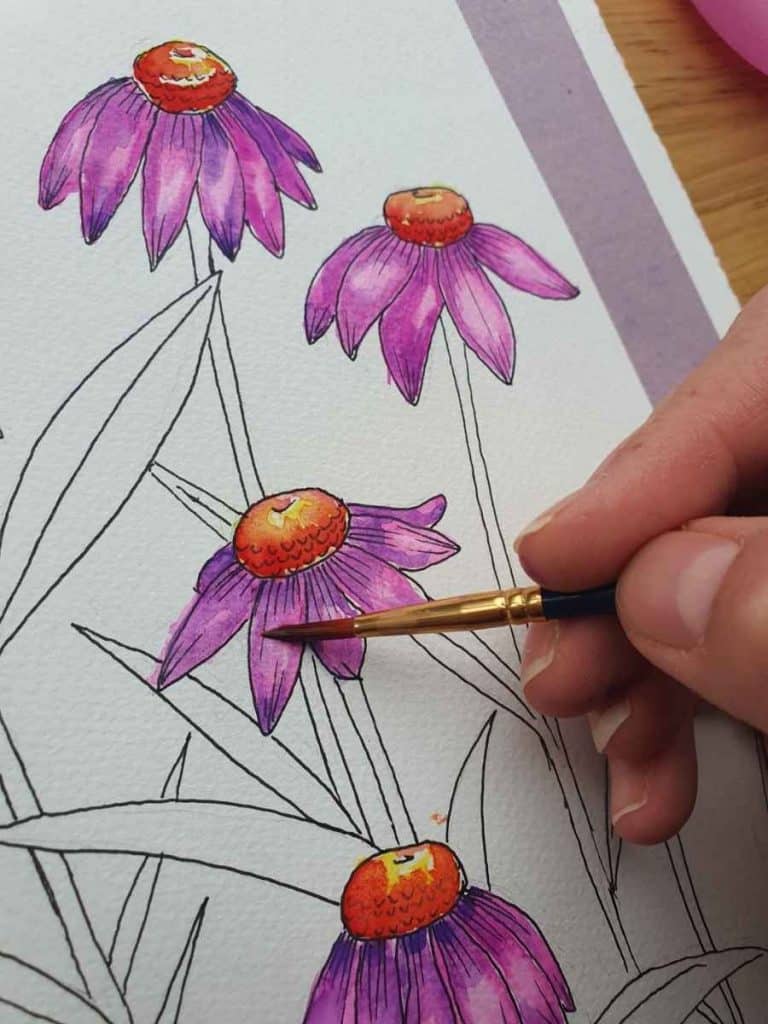 daisies with a hand painting their petals purple
