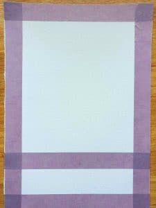 purple masking tape across a white sheet of paper