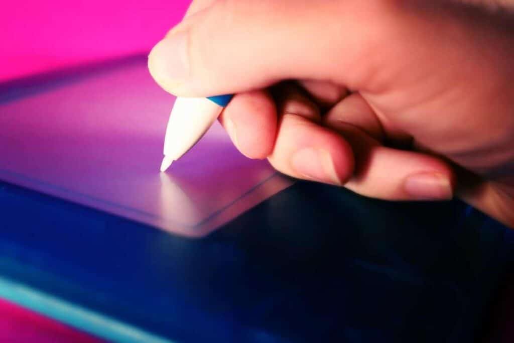 a hand drawing on a tablet demonstrating digital painting tips 