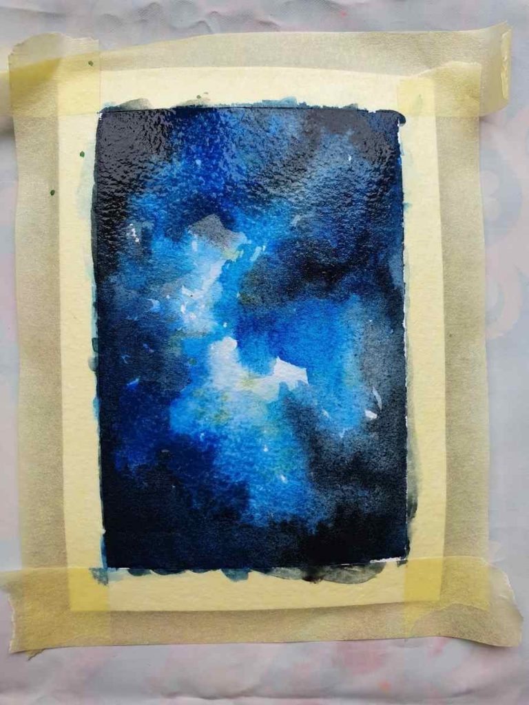 blue watercolor painting on a white piece of paper