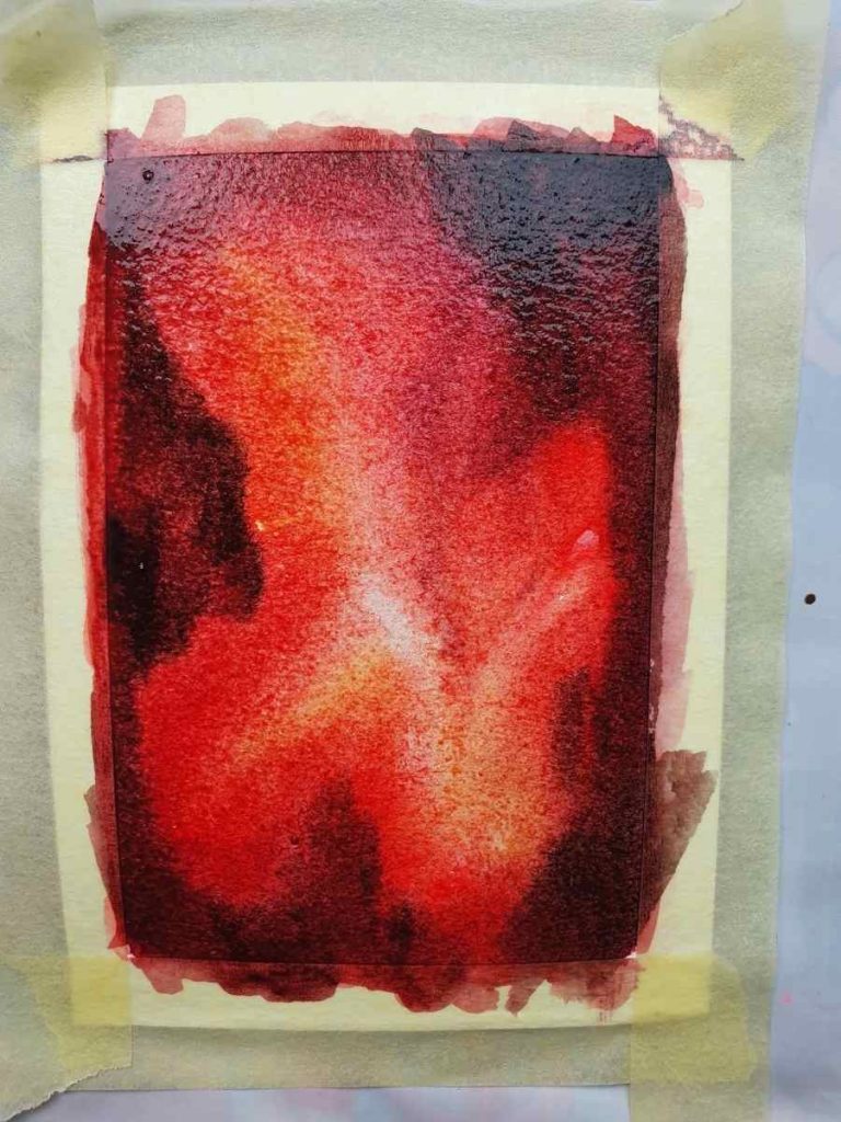 red watercolor painting on white paper