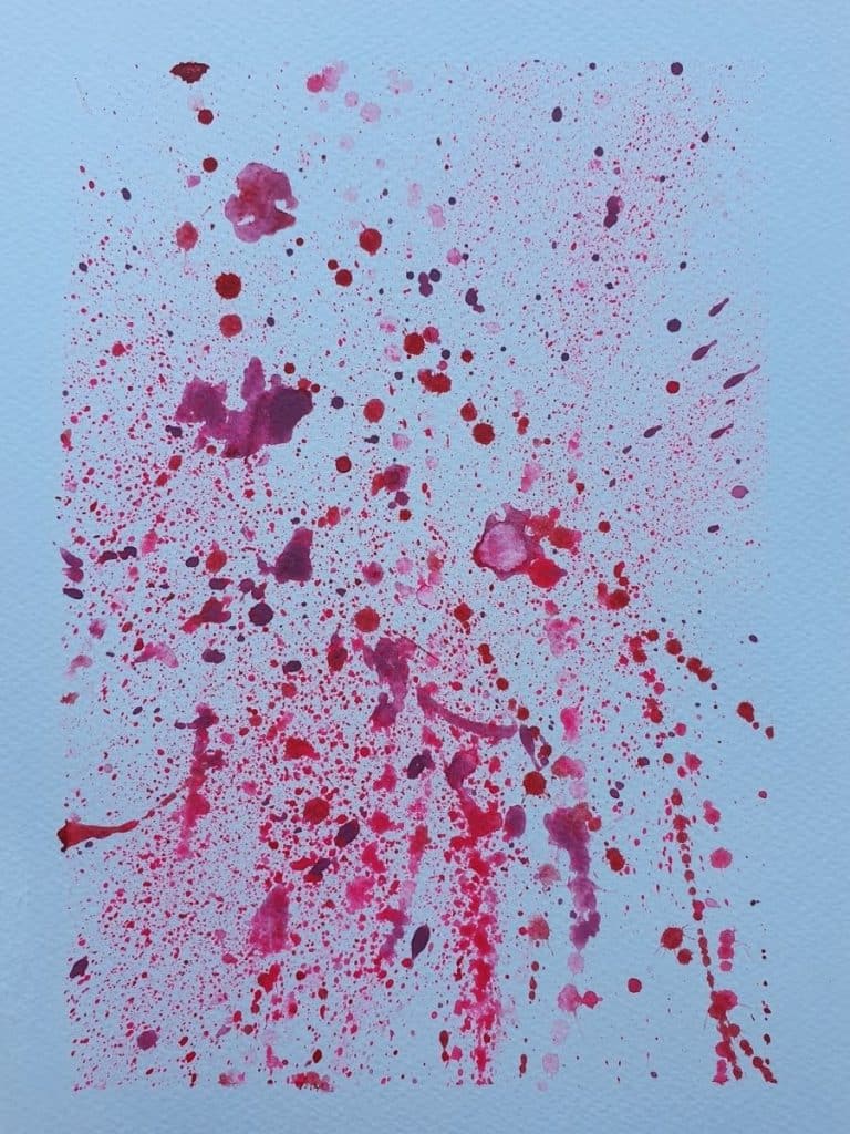 red and pink watercolor paint splatter background